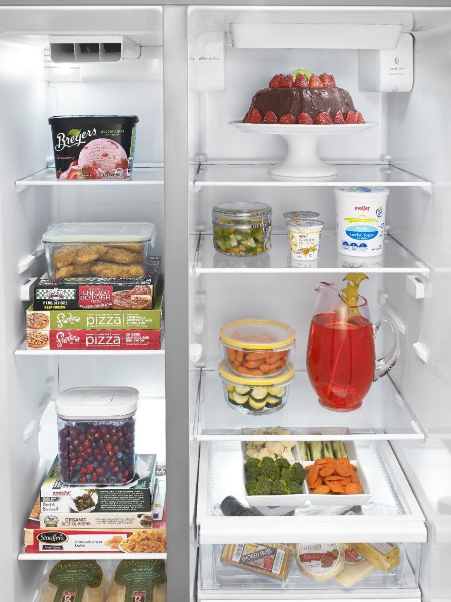 View of side-to-side freezer and fridge compartments with food View of side-to-side freezer and fridge compartments with food
